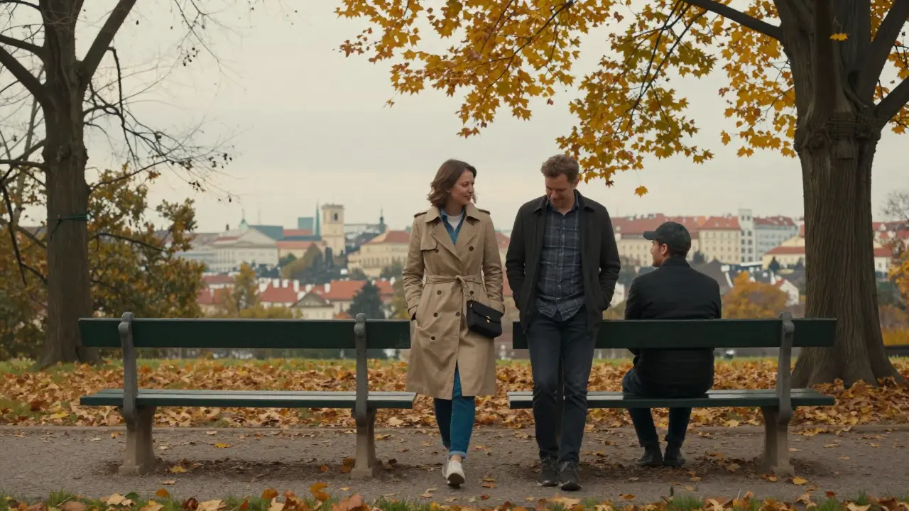 A woman and man walking together in a Prague park, sharing a peaceful moment under autumn leaves.